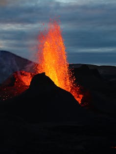 A volcano with lava spewing into the air.