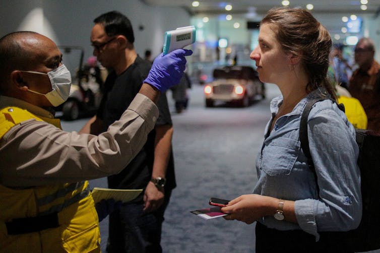 Person getting temperature tested at airport