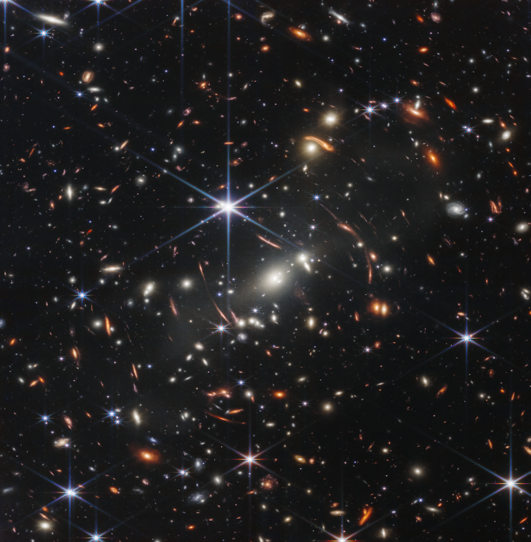 Many galaxies, indicated as small, bright dots, shown against a dark backdrop.