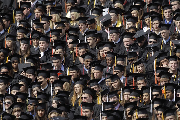 College graduates wearing graduation regalia.