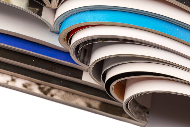 closeup of a stack of open magazines