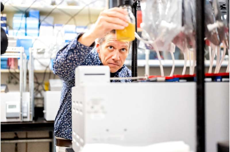 Associate Professor Matthias Hess demonstrates a bioreactor used to study reducing methane emitted by cow burps at UC Davis in California