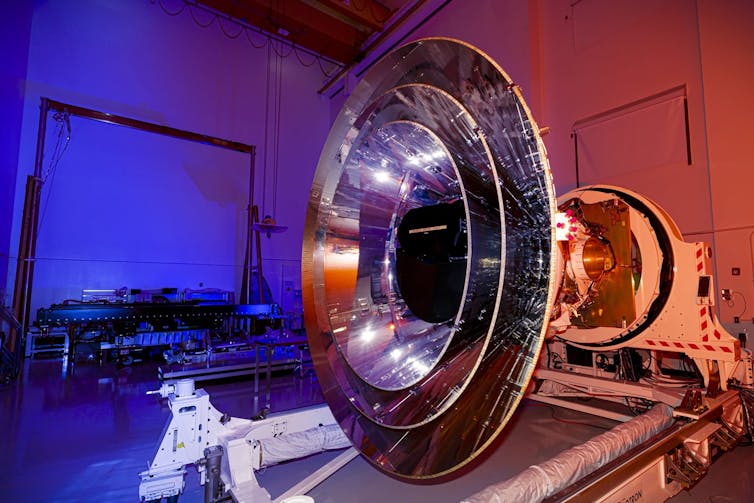 The SPHEREx observatory, which is made up of several nested metal cones, sitting on a platform.