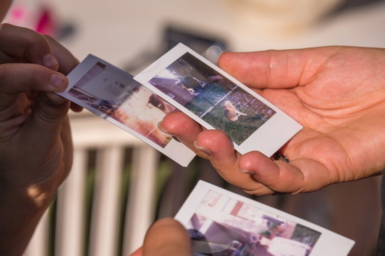 Hands holding polaroids