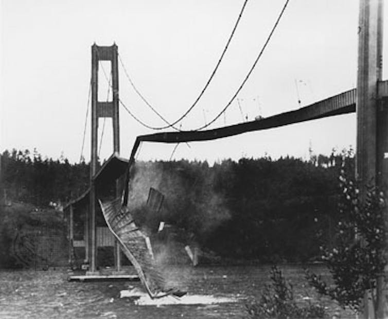 A bridge collapsing into a river.