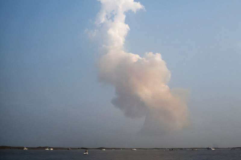 A plume of exhaust from the rocket boosters is left behind after the SpaceX Starship rocket launched from Starbase, Texas, as seen from South Padre Island on May 27, 2025
