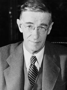 A black-and-white photograph of Vannevar Bush wearing a suit and tie.