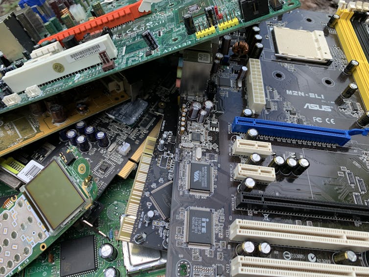 Multiple printed circuit boards laid on top of one another.