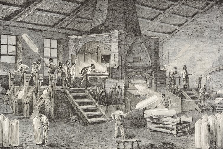 An engraving of people working on glass factory, with a large furnace in the center
