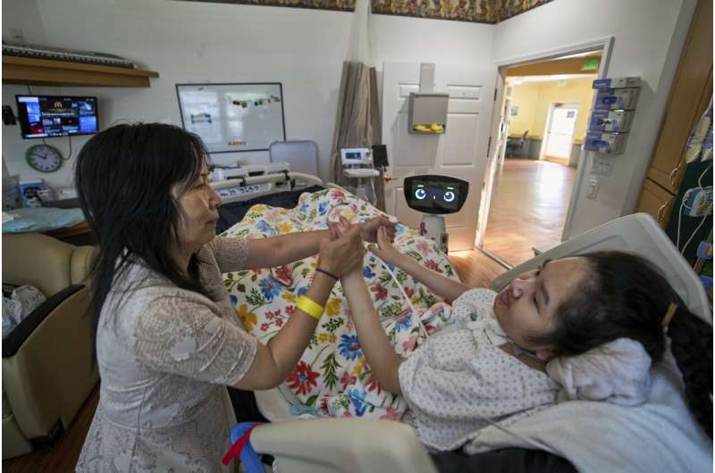 A robot programmed to act like a 7-year-old girl works to combat fear and loneliness in hospitals