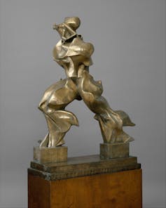 a bronze sculpture of a human form with bulging, distorted leg muscles and no arms