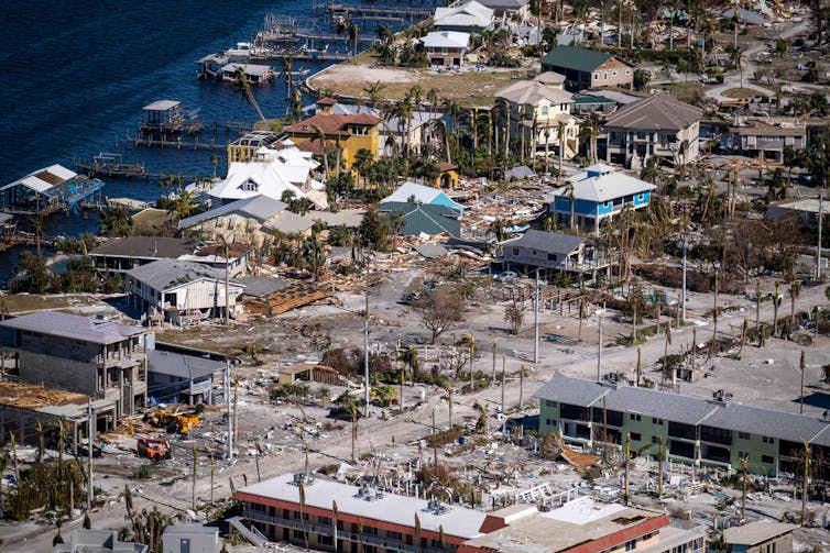 A coastal area with severe damage to homes and others buildings.