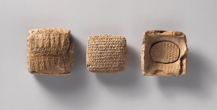 Three clay artifacts with glyphs and figures inscribed
