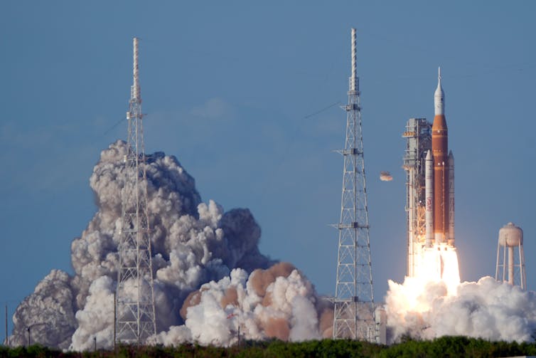 The Space Launch System rocket lifting off the launchpad